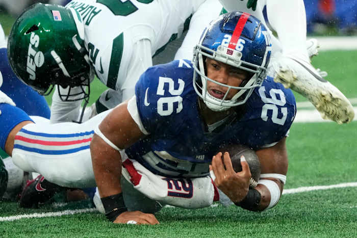 Barkley (26) is shown with the ball against the Jets. The Giants' star running back is on the verge of hitting free agency and there is plenty of debate over his uncertain future with Big Blue.
